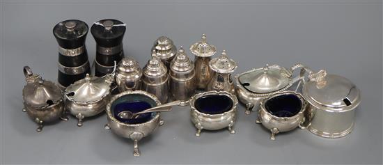 A six-piece silver cruet set, two pairs of urn peppers, a pair of silver-mounted pepper mills, a mustard and three other items